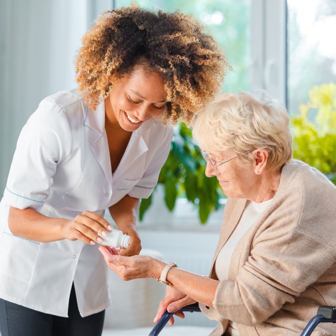 A female nurse helping a woman with her medication.