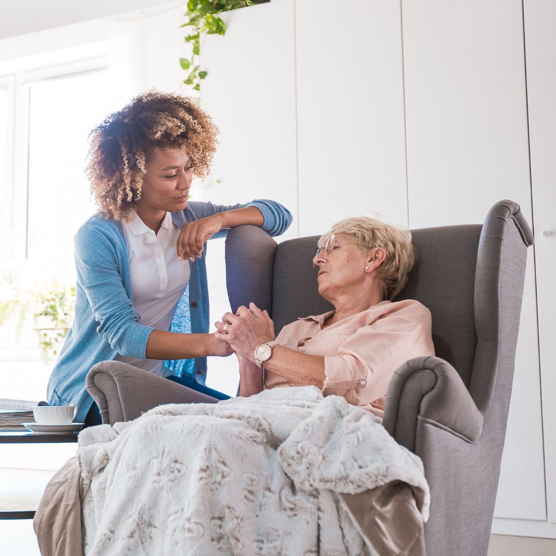 A nurse and an elderly woman talking.