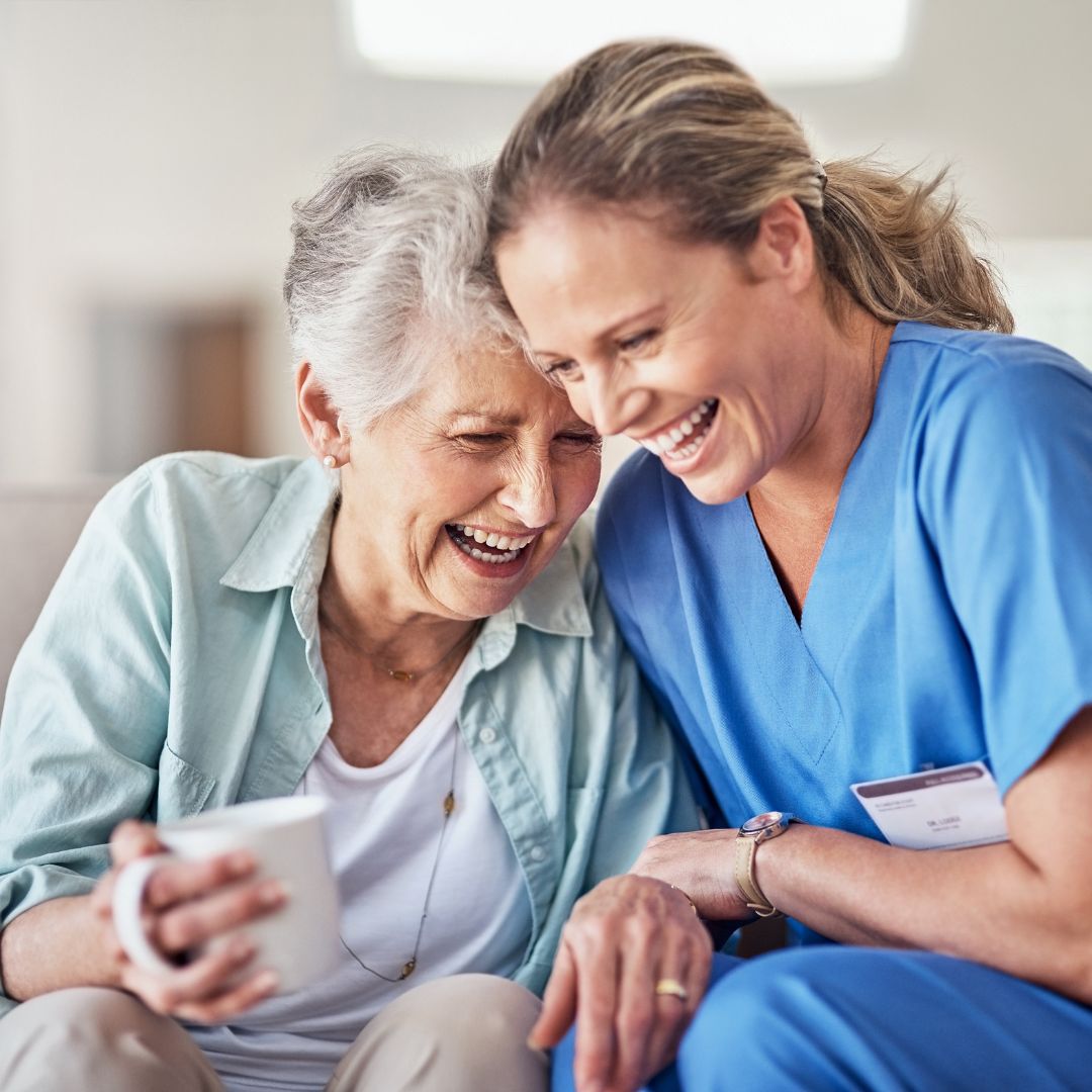 Nurse and her patient laughing together