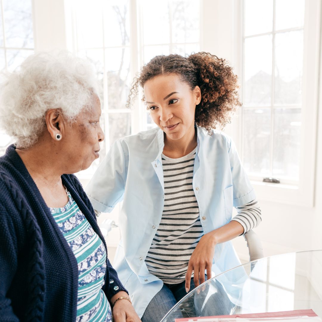 Woman talking with elderly woman