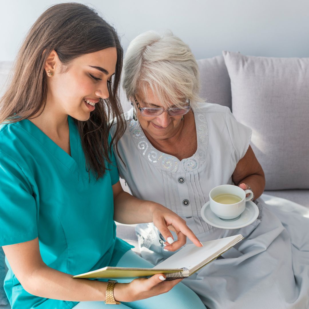 Senior care nurse reading with a woman