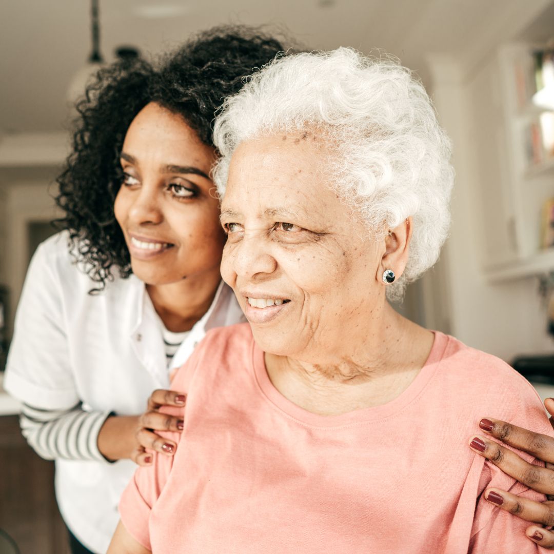 Woman looking out the window with nurse